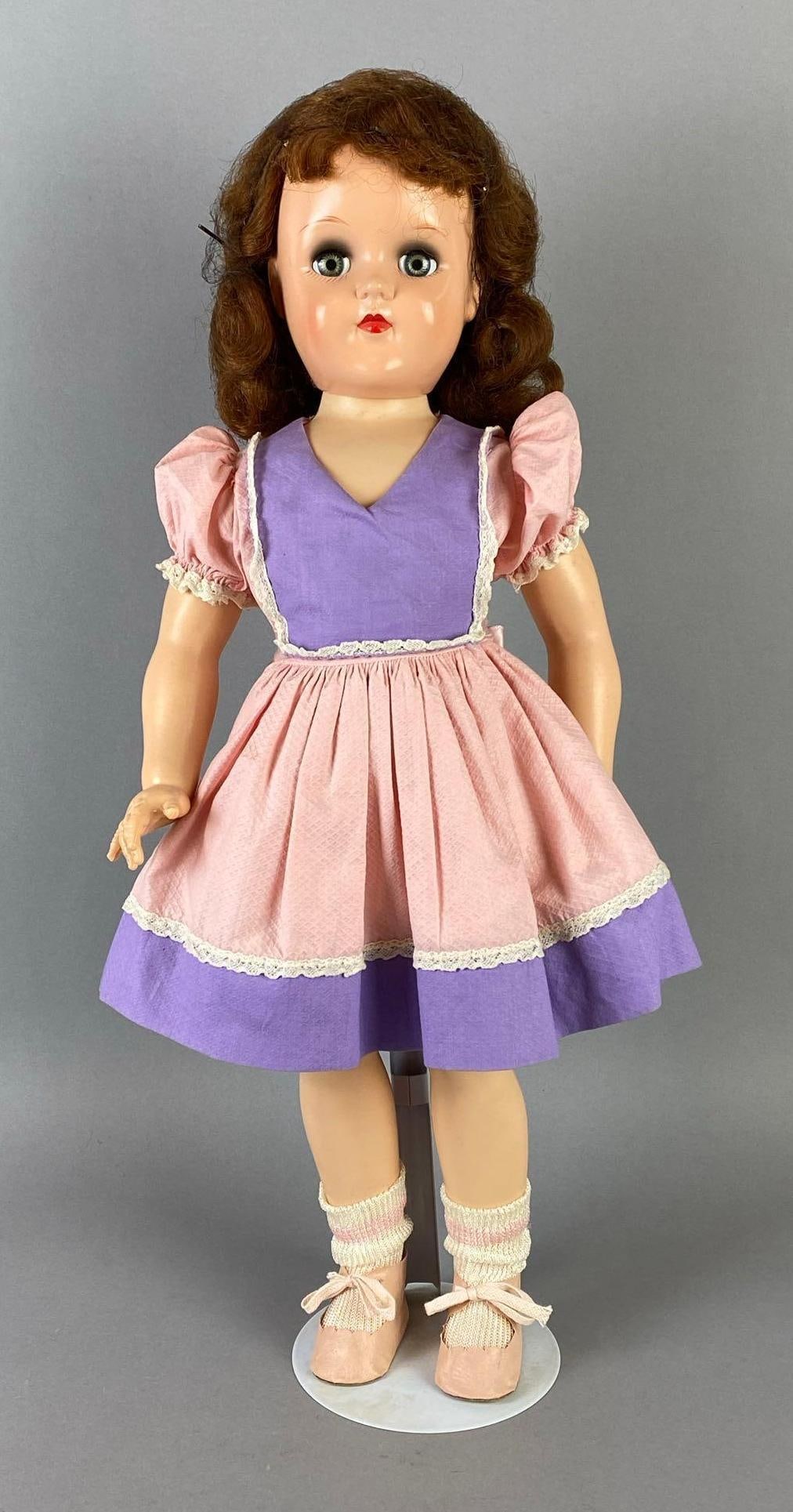 Vintage Ideal Toni P-93 Brunette Doll: Blue-Grey sleepy eyes, Doll stand included, Doll measures 20 1/2 inches tall.
