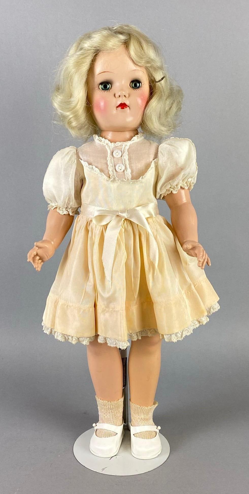 Vintage Ideal Toni P-92 Blonde Doll: Blue sleepy eyes, Doll stand included, Doll measures 19 inches tall.