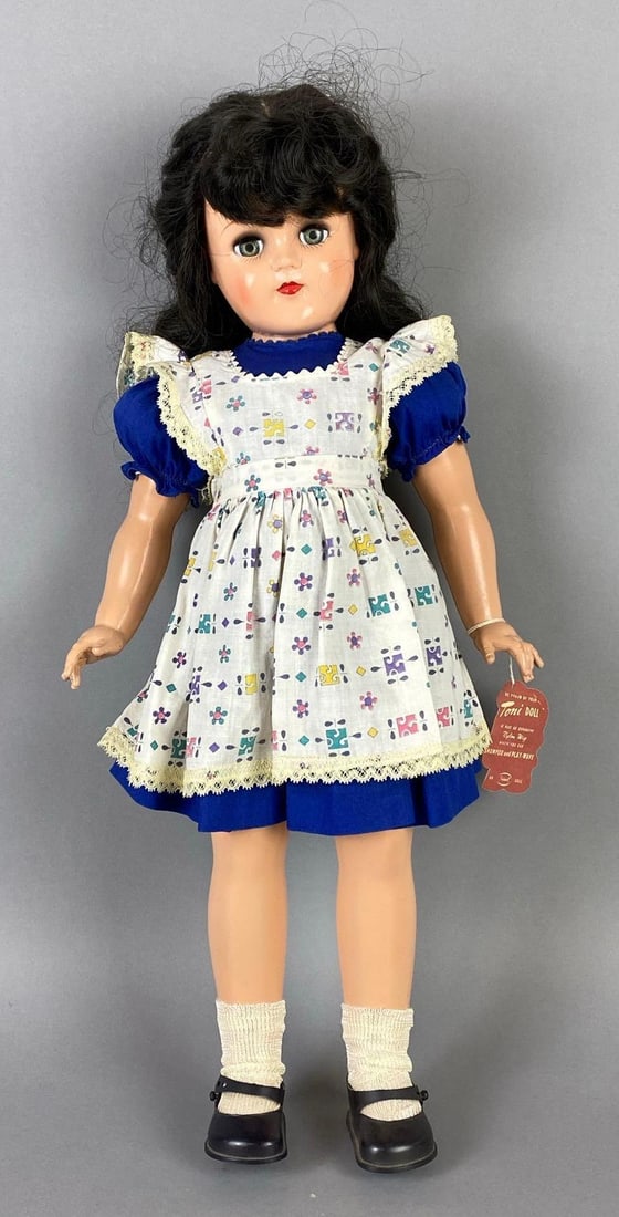 Vintage Ideal Toni P-93 Black Hair Doll: Green sleepy eyes, With reproduction tag, Doll measures 20 1/2 inches tall.