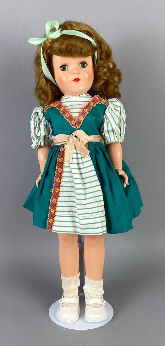 Vintage Ideal Toni P-92 Blonde Doll: Blue sleepy eyes, Cloudy eyes, Small mark on nose, Discoloration on hands, Doll stand included, Doll measures 19 inches tall.