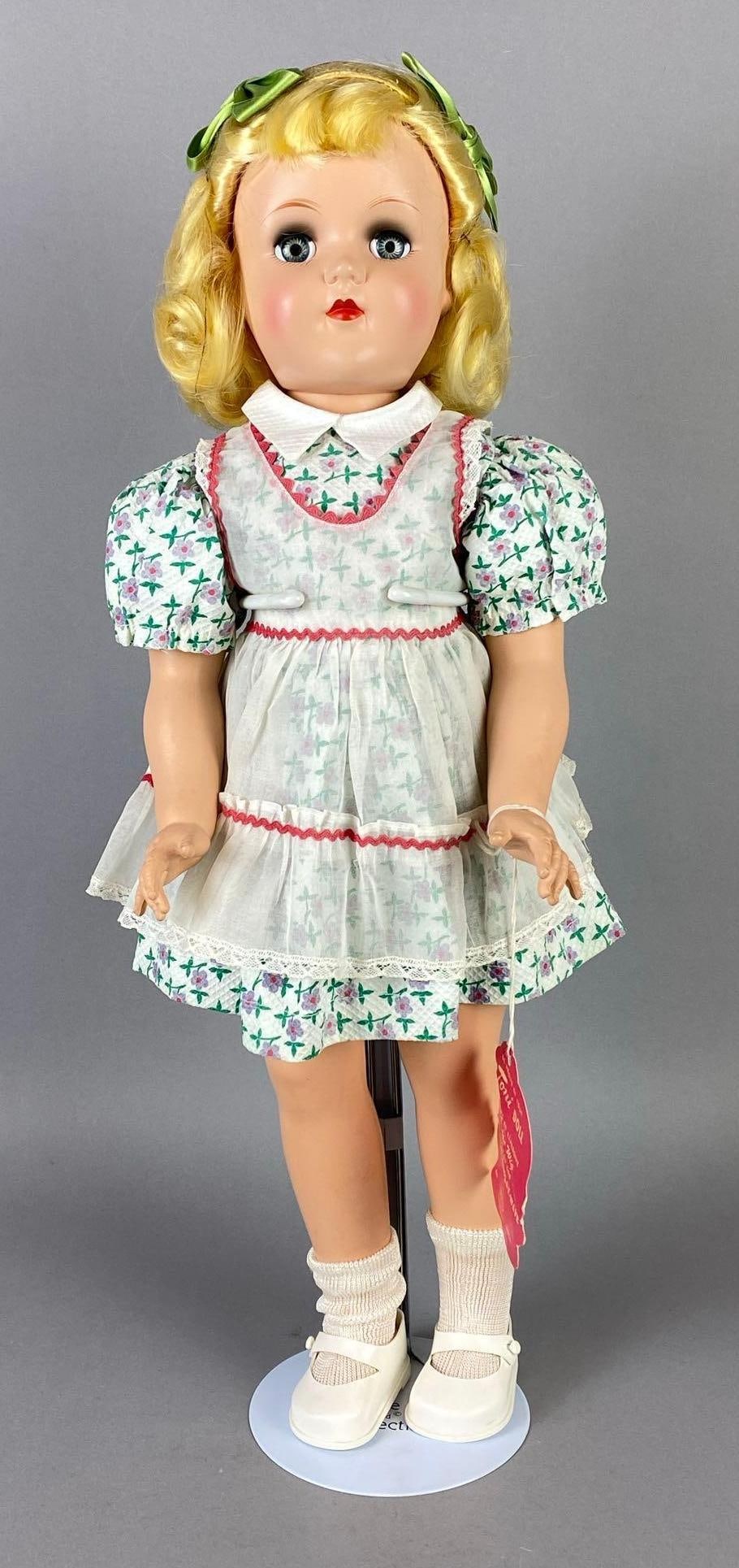 Vintage Ideal Toni P-93 Blonde Doll: Blue sleepy eyes, With tag, Doll stand included, Doll measures 20 1/2 inches tall.