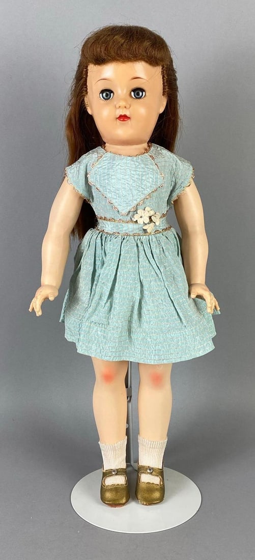 Vintage Ideal Ruth V-93 Brunette Doll: Blue sleepy eyes, With P-93 Toni body, One eye lazy, With additional outfit, Doll stand included, Doll measures 20 inches tall.