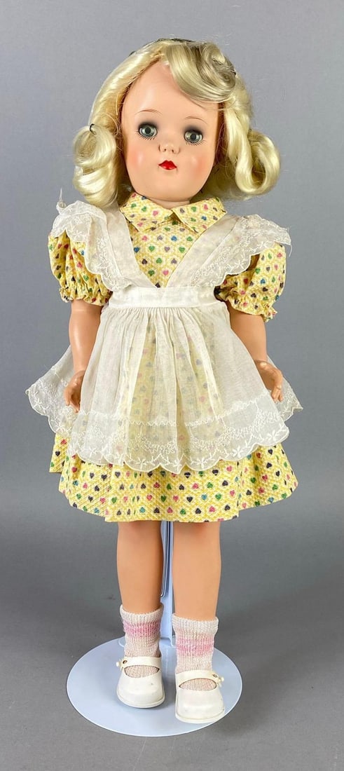 Vintage Ideal Toni P-92 Blonde Walker Doll: Blue sleepy eyes, Eyes cloudy, Neck frozen, Doll stand included, Doll measures 19 inches tall.
