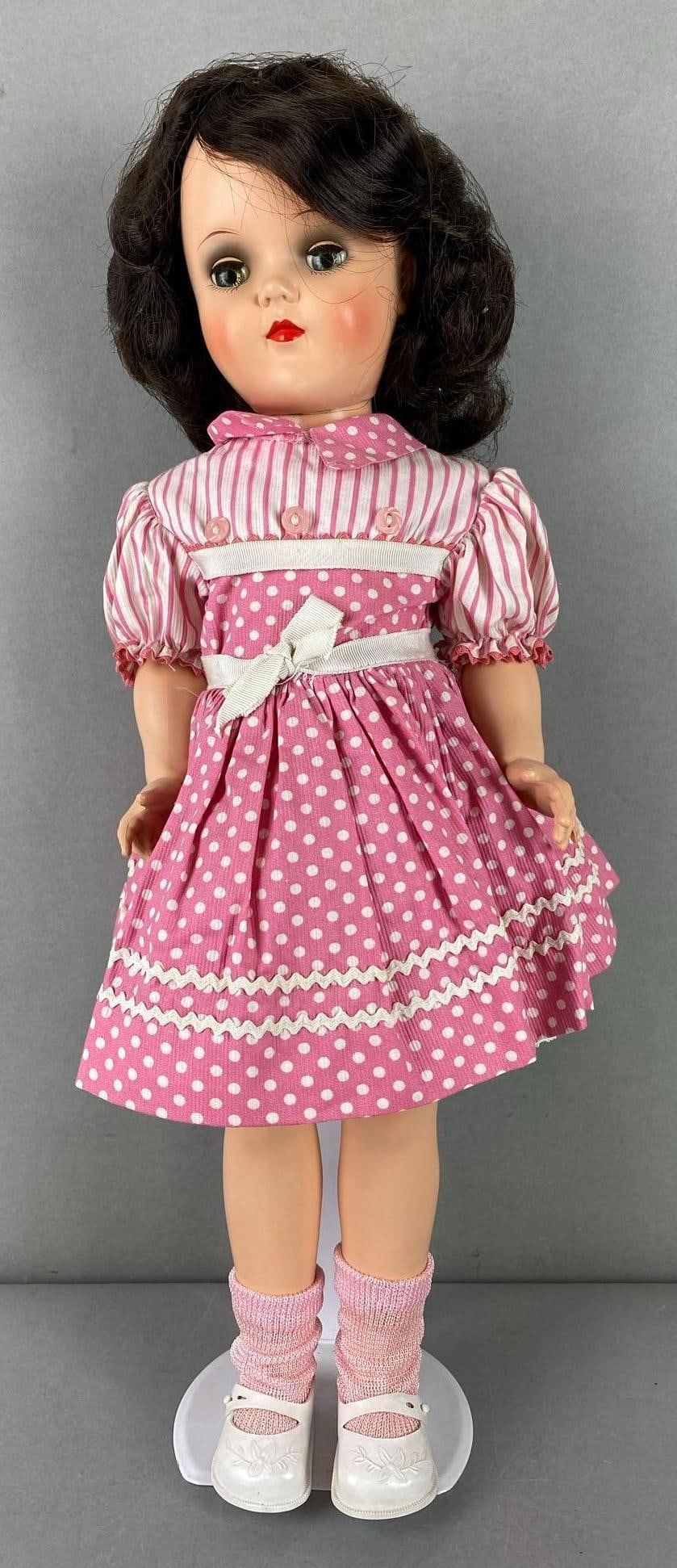 Vintage Ideal Toni P-92 Brunette Doll: Green sleepy eyes. Includes stand. Measures 16 inches tall.