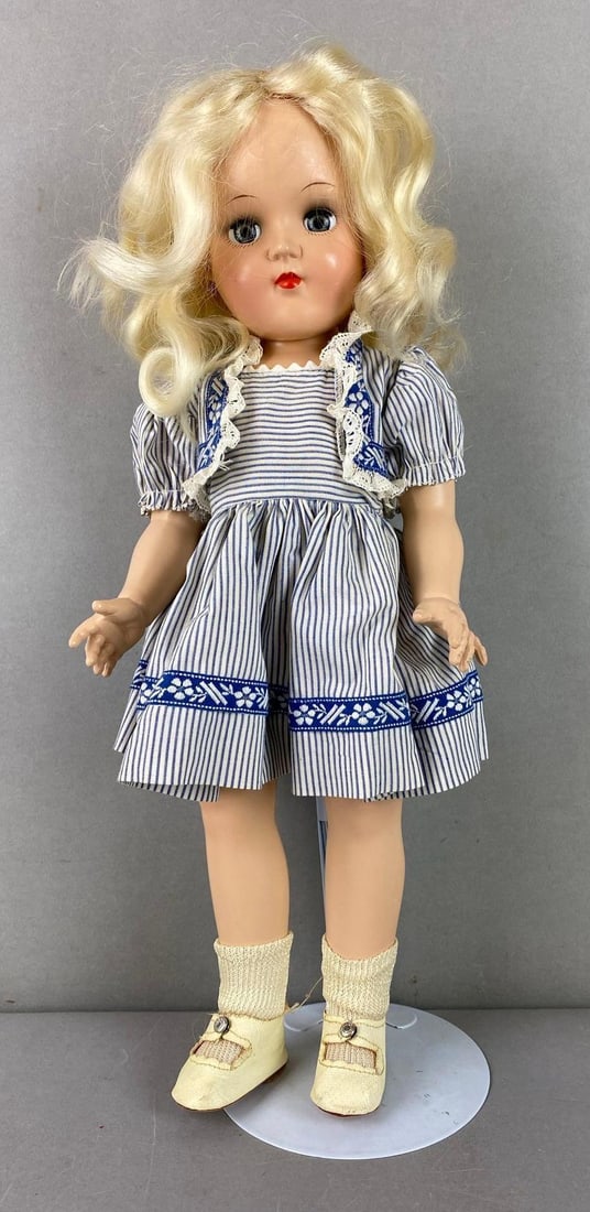 Vintage Ideal Toni P-91 Blonde Doll: Has blue sleepy eyes. Includes stand. Measures 15 inches tall.