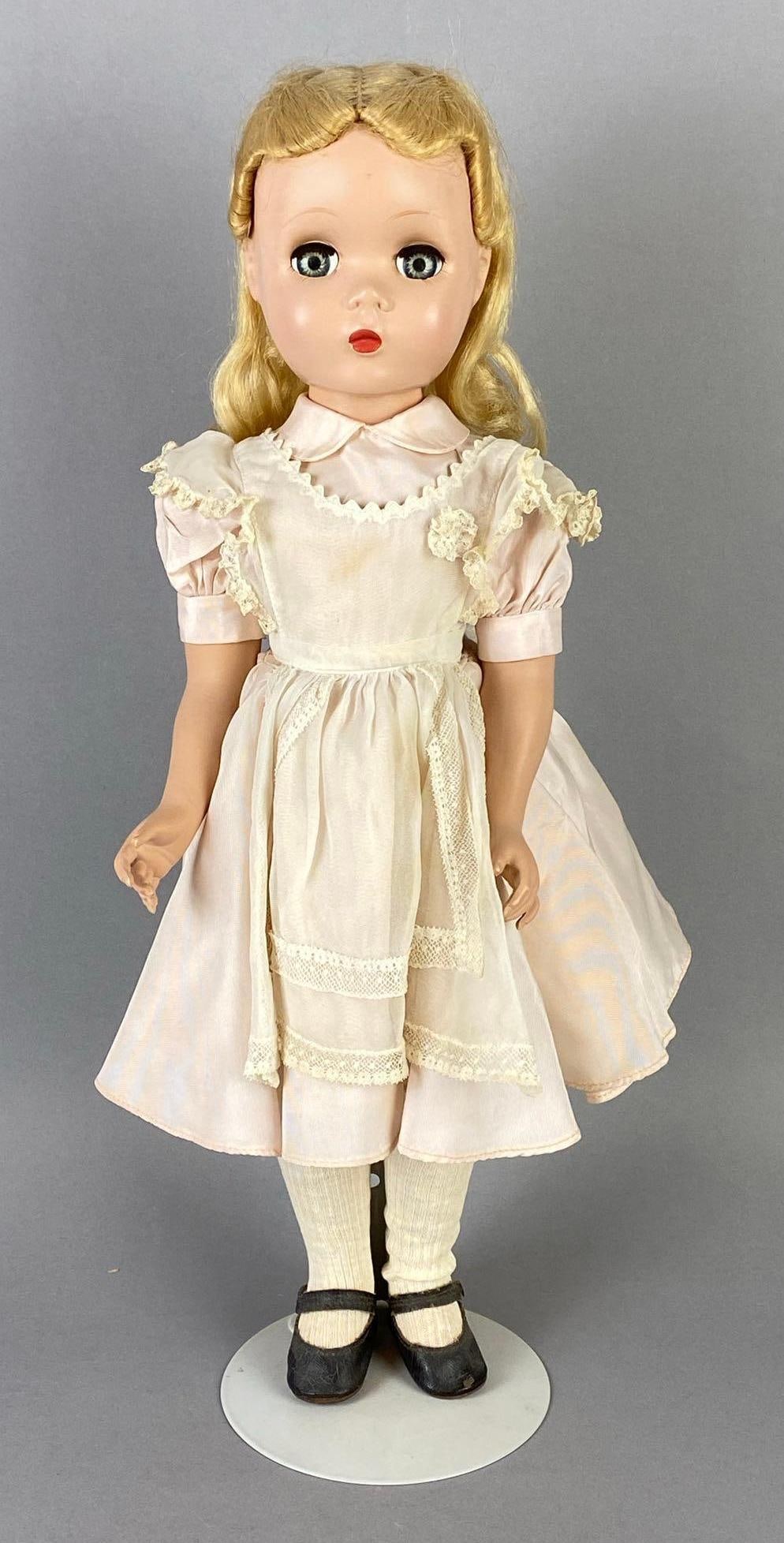 Vintage Madame Alexander Alice in Wonderland Doll: Blue-Green sleepy eyes, Eyes stuck open, Doll stand includes, Doll measures 17 inches tall.