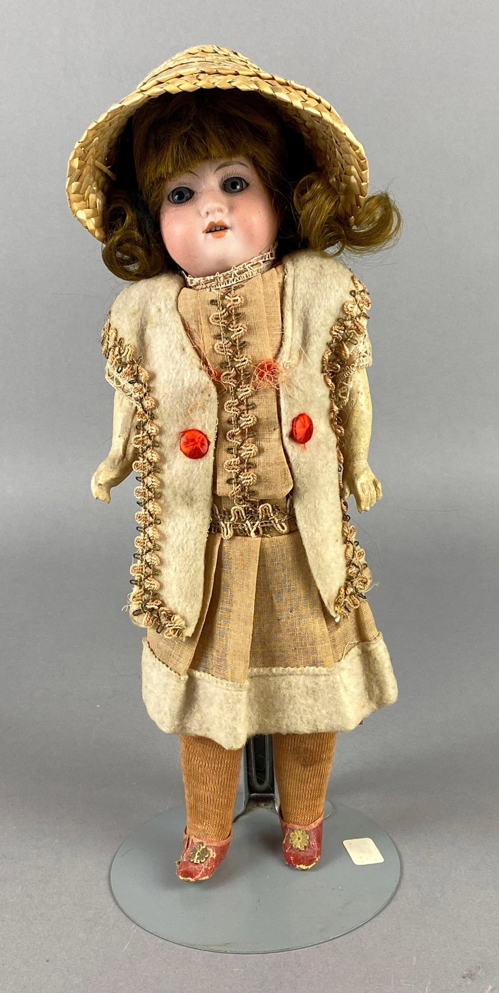 Antique Armand Marseille Porcelain Doll: Porcelain head with composite doll, Blue eyes, Open mouth, 4 teeth, Doll stand included, Doll measures 12 inches tall.