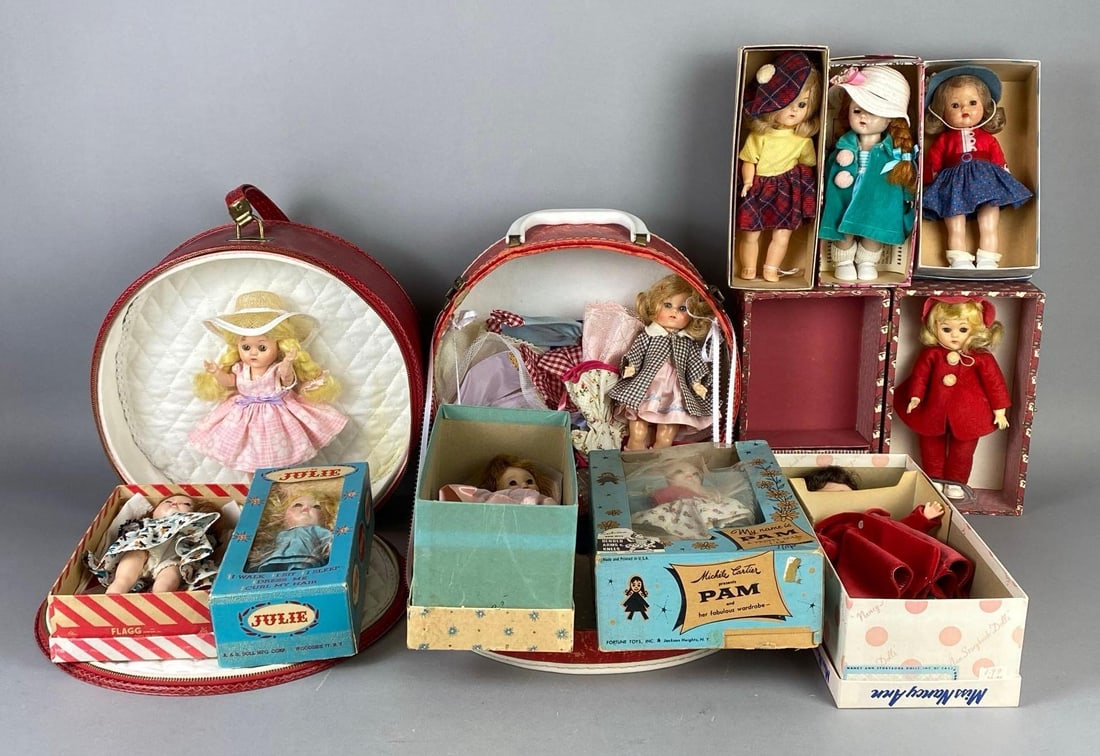 Group of Assorted Dolls: Some with original boxes and vases, Includes Pretty Pam, A and H Julie, Nancy Ann, and more, Includes some accessories, Some tears in boxes, Largest carrier measures 10 x 11 1/2 x 4 inches.