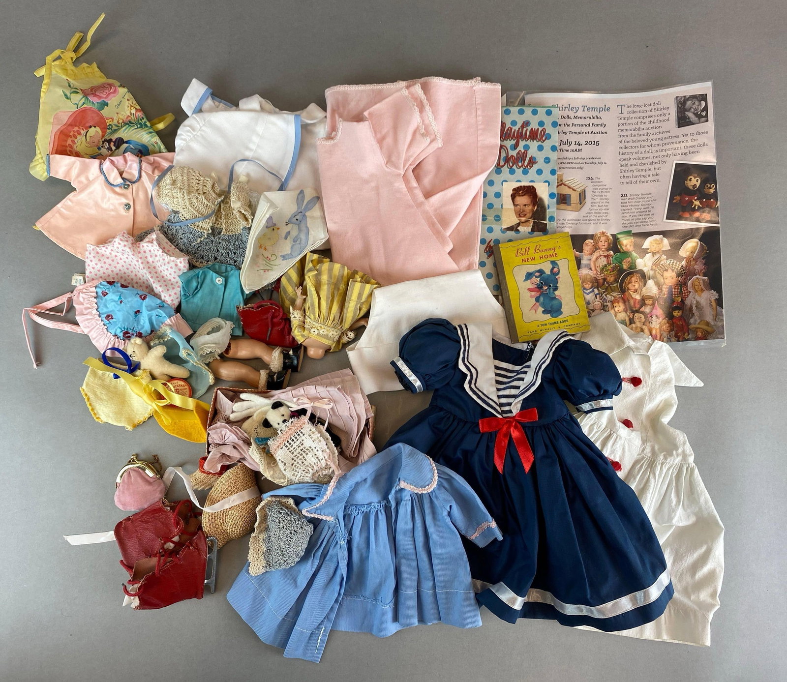 Group of Assorted Vintage Doll Clothing and More: Includes ephemera, shoes, dresses and more, largest clothing item measures 13 x 11 inches
