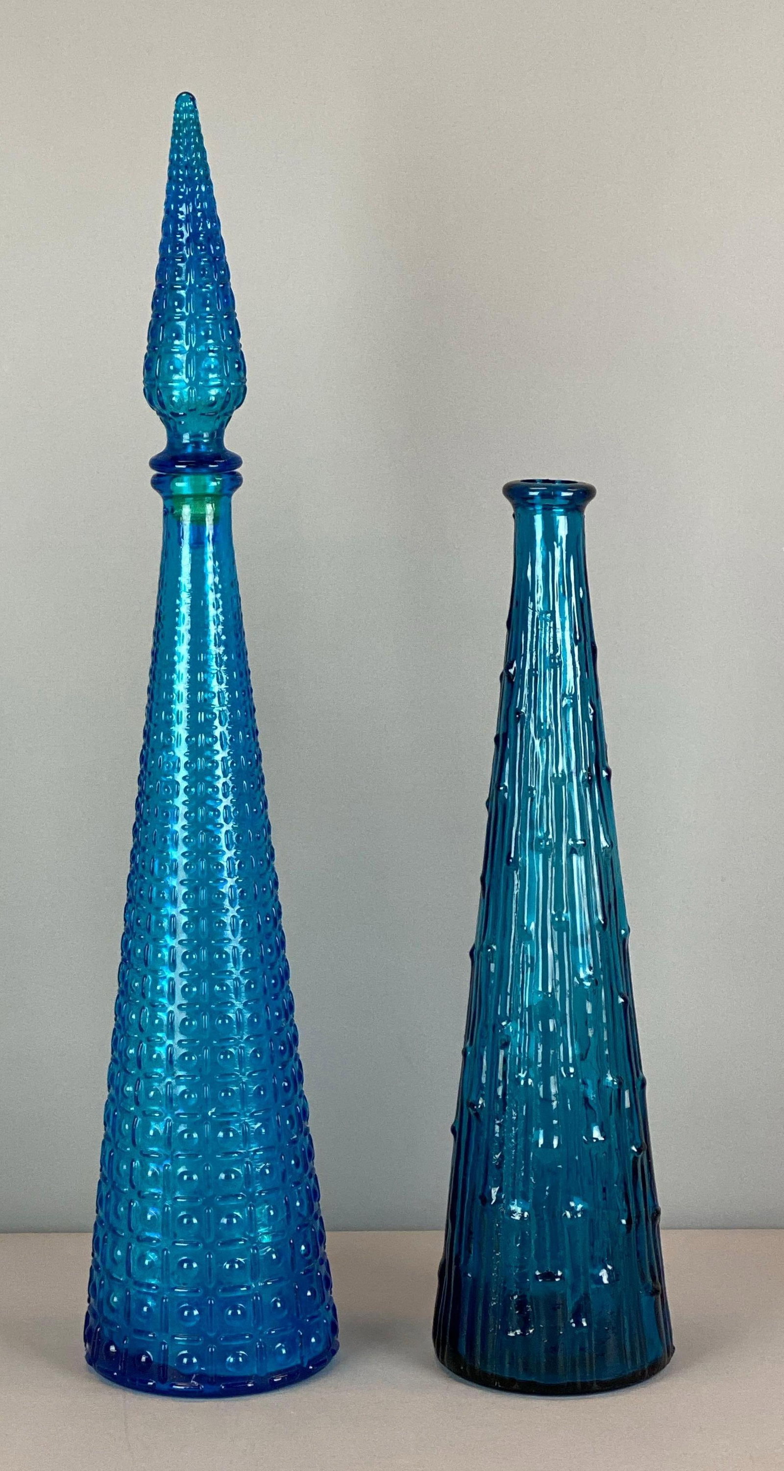 Group of 2 Cobalt Textured Glass Decanters: One marked made in Italy, one missing stopper, largest measures 21 3/4 x 4 1/2 inches
