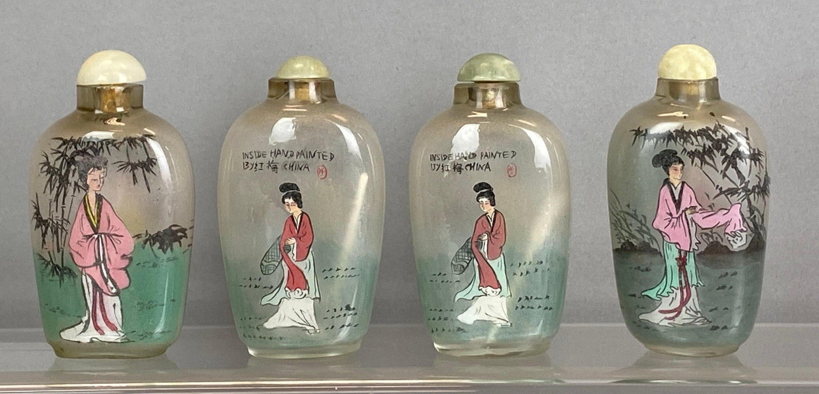 Group of 4 Chinese ROG Woman Snuff Bottles: Reverse on glass, largest measures 3 1/4 x 1 1/2 inches
