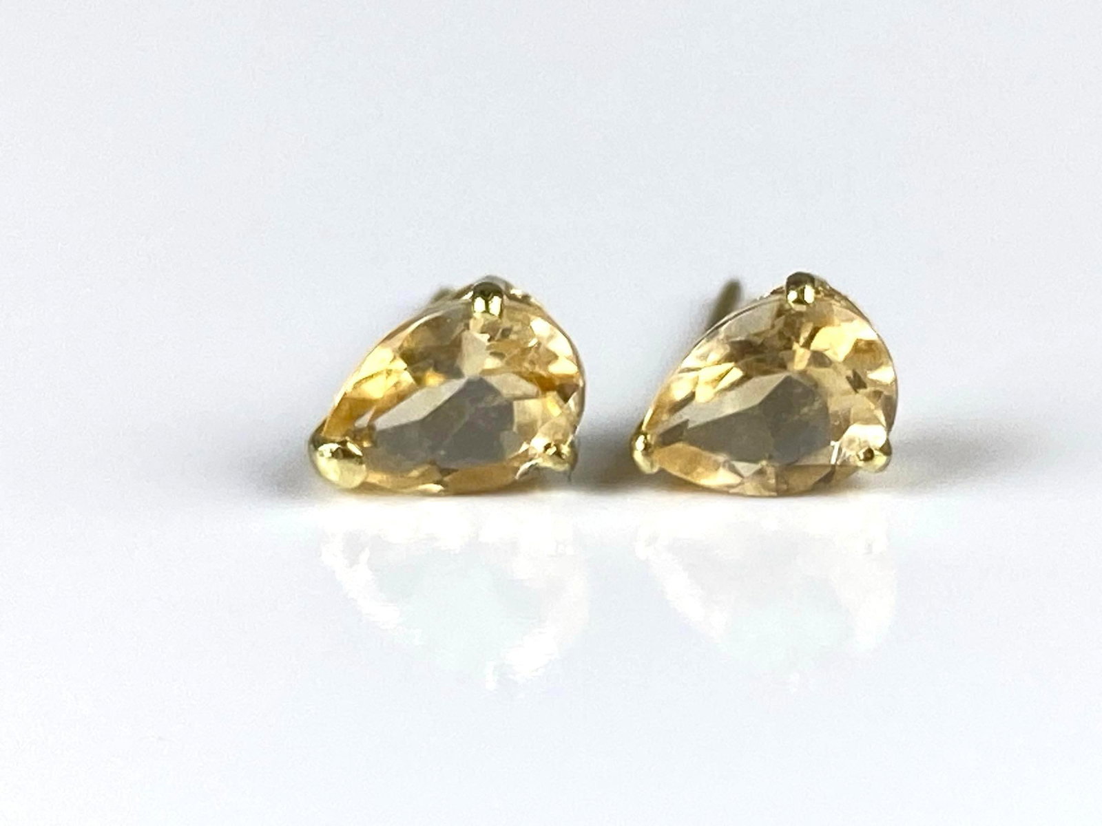 14K Gold Yellow Spinel Stud Earrings: Total weight 0.6g, Both measure 1/4 inch long.