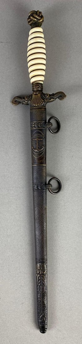 WW1 German Marine/Navy Engraved Officers Dagger with Scabbard: Engraved K.U.K. Marine 1915 on blade, Seashell embellishment on guard, Makers mark on blade, Dagger measures 15 3/4 inches long, Blade measures 11 inches long.