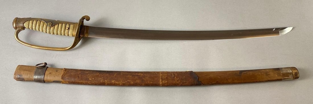 WW2 Era Japanese Officers Sword with Wood/Leather Sheath: Gendalt Family Creat on guard, Sharkskin hilt, Floral accents, Sword measures 29 1/2 inches long, Blade measures 22 inches long.