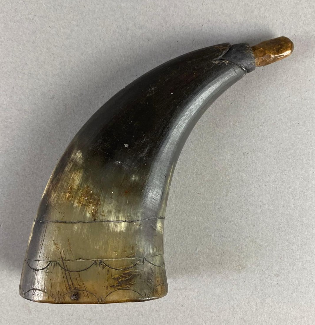 Engraved Black Powder Horn: Engraving along bottom edge, Crack along back side, Measures 4 1/2 x 4 1/2 x 1 1/2 inches.