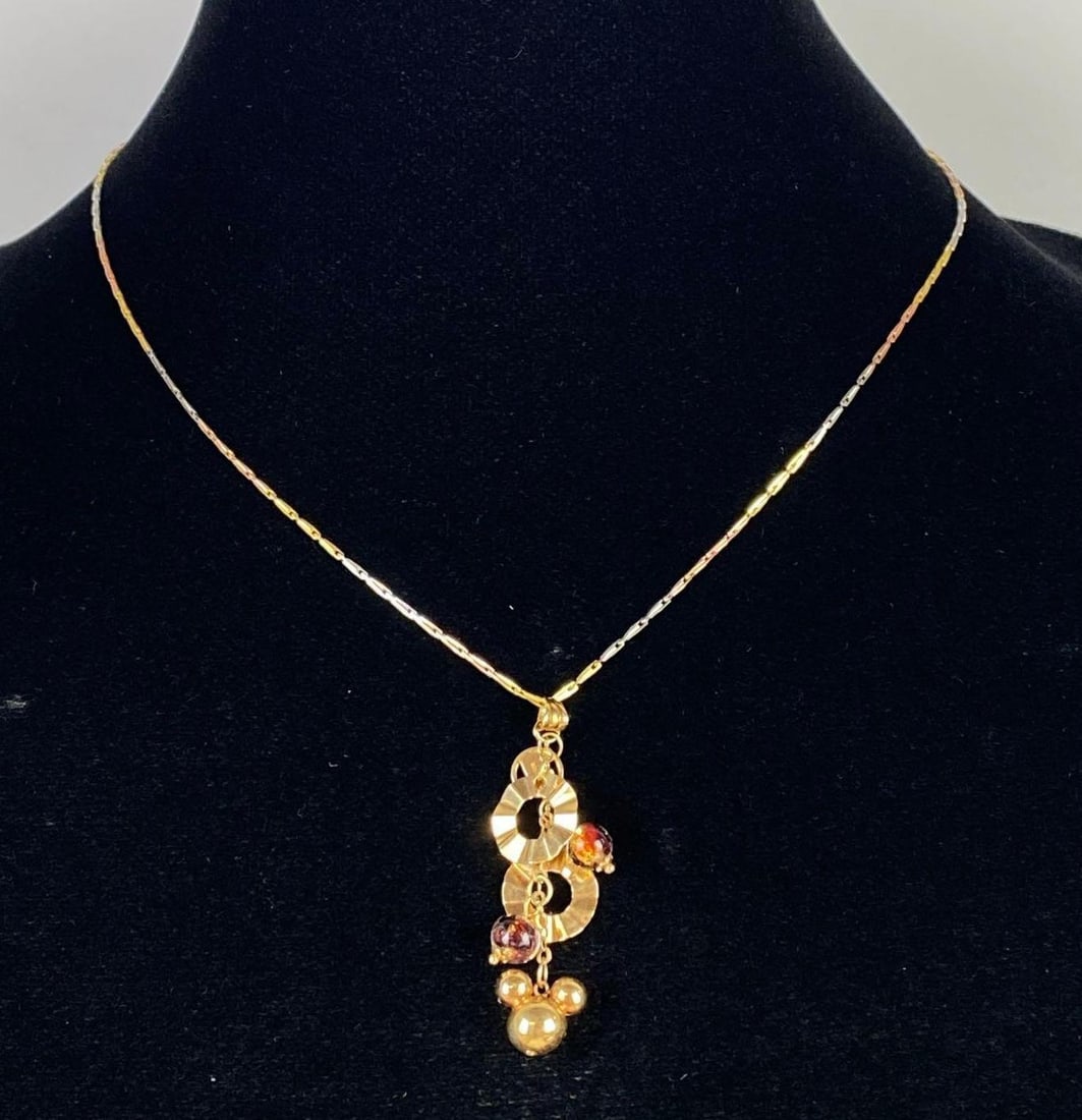 18K Italian Gold Chow Sang Sang Walt Disney Pendant Necklace: Total weight 6.4g, Gold, white gold, and rose gold chain, Chain measures 17 inches long, Pendant measures 1 3/4 inches long.