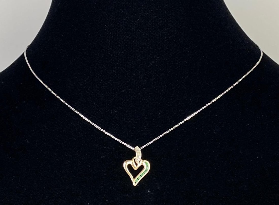 14K White Gold Chain with 10K Gold Emerald Heart Pendant: Chain weighs 1.0g, Pendant weighs 0.9g, Chain measures 15 inches long, Pendant measures 3/4 inch long.