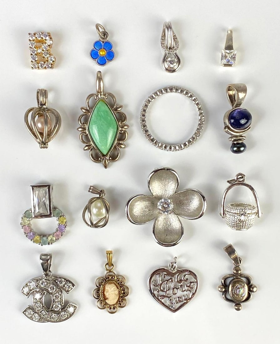 Group of Sterling Silver Necklace Pendants and More: Includes necklace pendants, ring, and more, Includes flowers, cameo, I love you, Largest measures 1 1/2 inches long.