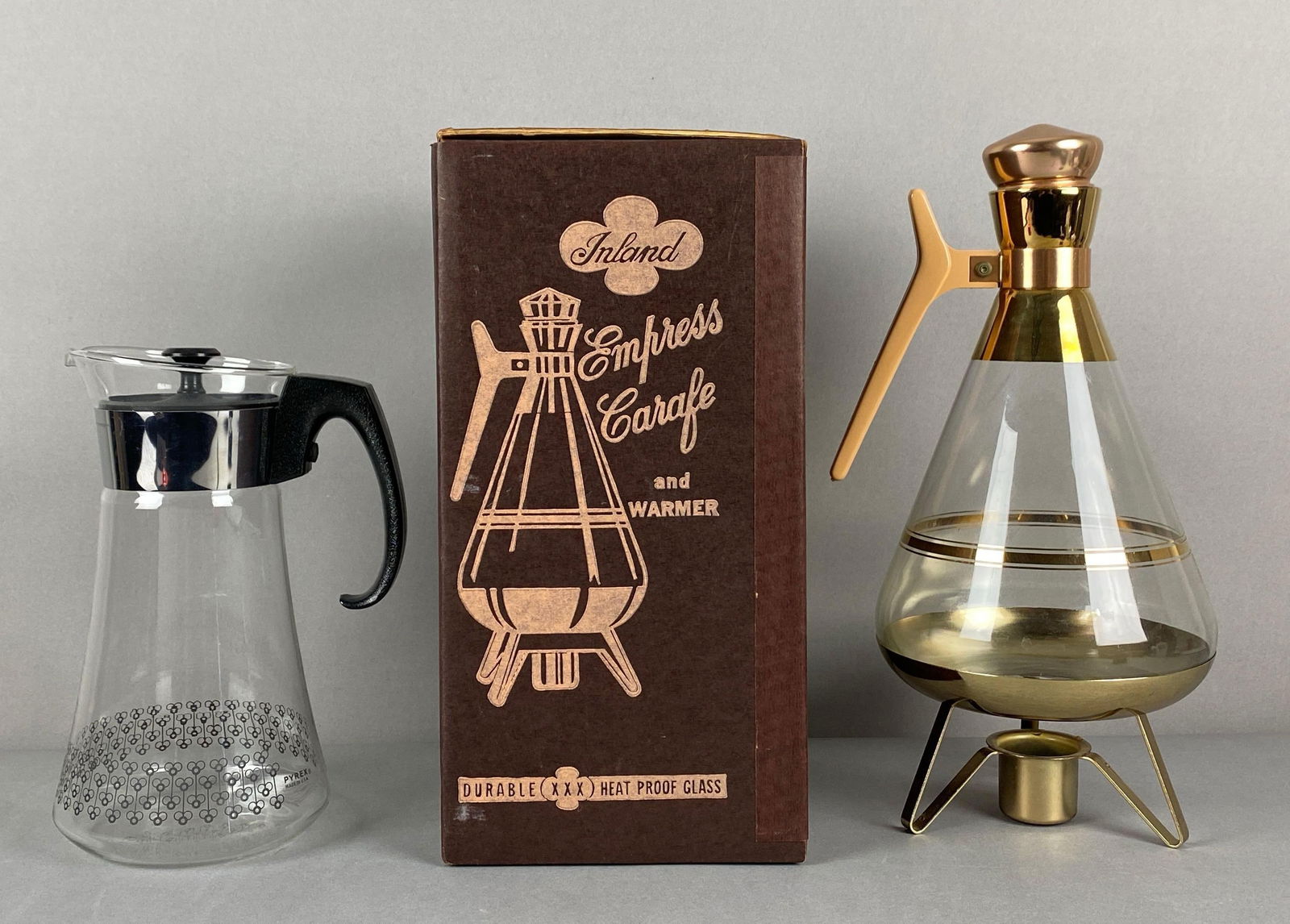 Group of 2 Glass Carafes: Include pyrex and Inland in original box, largest measures 14 x 7 1/2 x 6 1/2 inches