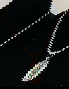 Sterling Silver Native American Turquoise Pendant Necklace: Possibly Zuni Jobeth Mayes design, Chain measures 20 inches long, Pendant measures 2 1/4 inches long.