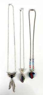 Group of 3 Sterling Silver Native American Pendant Necklaces: Includes feather design with onyx, rainbow calsilica, and other, Longest necklace measures 17 inches long.