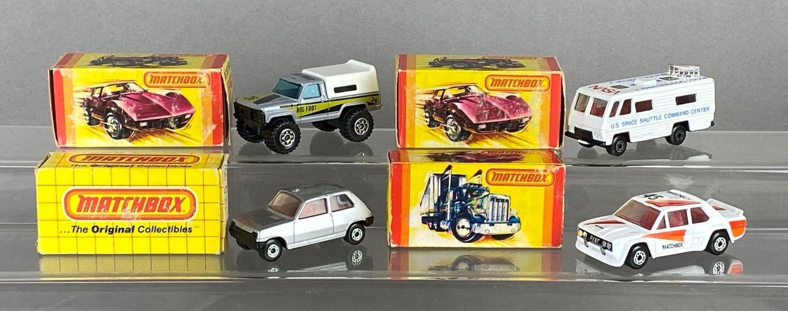 Group of 4 Matchbox Die-Cast Vehicles: With boxes, Some original boxes, Includes Bigfoot Monster Truck, NASA Tracking Vehicle, No. 21 Renault 5TL, and Fiat Abarth, Some tears in boxes.