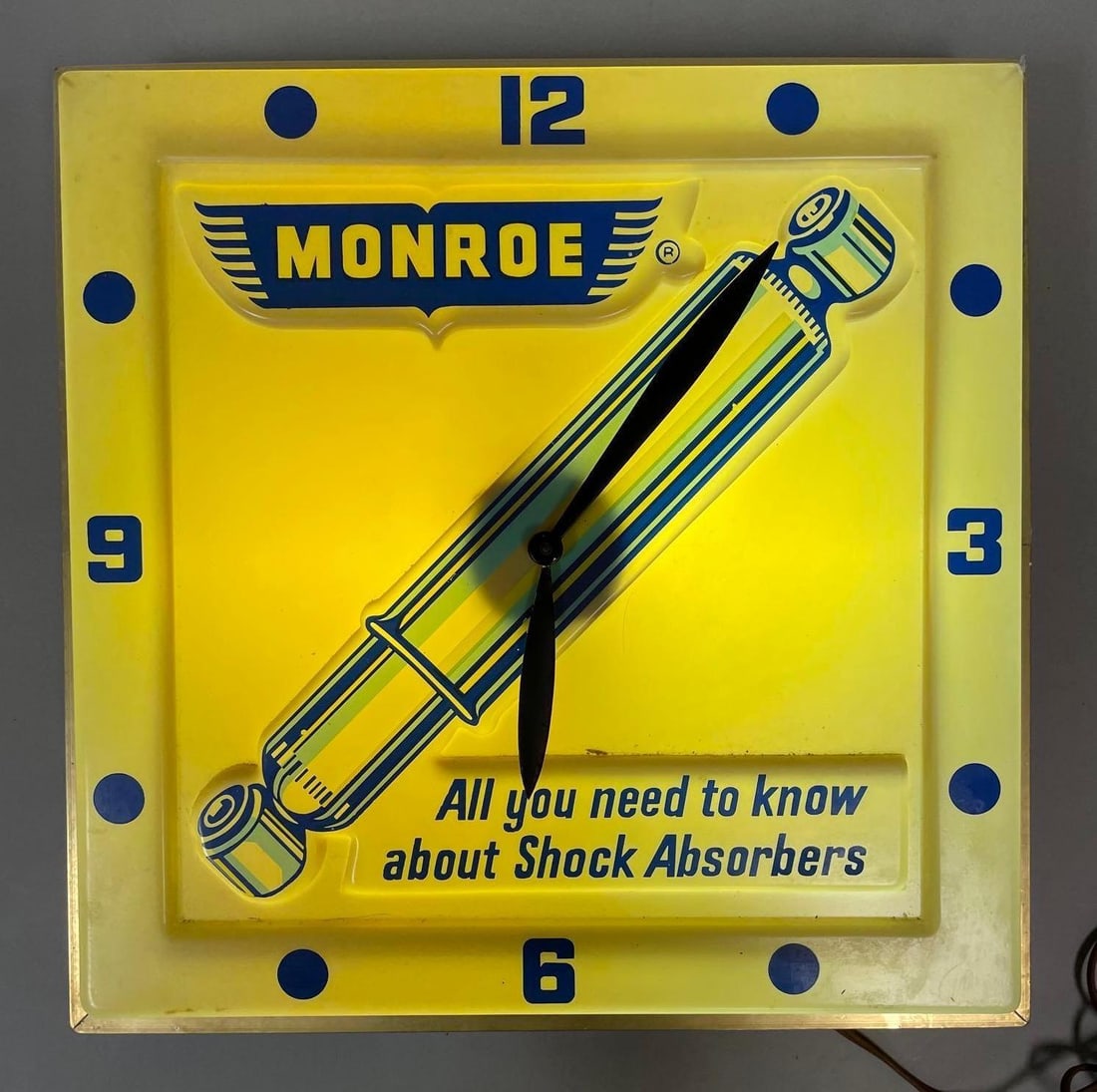 Monroe Shocks Light-Up Advertising Clock: Working condition, measures 16 x 16 x 4 inches
