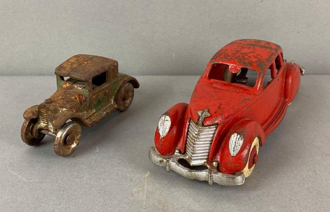 Group of 2 Cast Iron Cars: Includes Hubley and Arcade. Wear is consistent with age. Largest measures 2 1/4 x 7 1/4 x 2 3/4 inches.