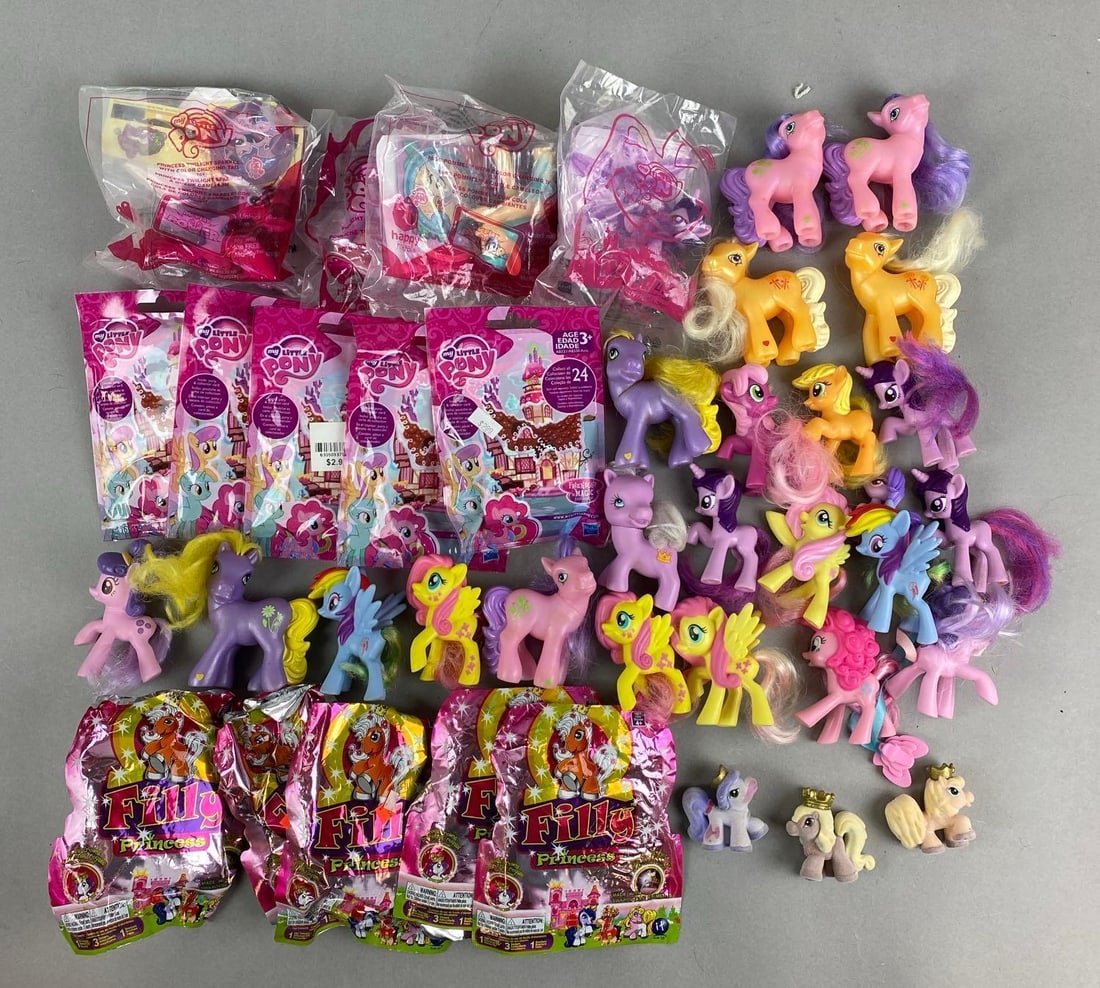Group of Hasbro My Little Pony toys and More: Includes opened Filly Princess mystery packs, unopened my little pony packs, unopened McDonald’s happy meal toy and more. Largest item measures 4 x 6 x 2 1/2 inches.
