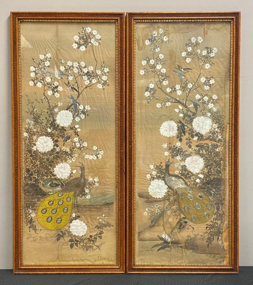 Set of Painted Silk Peacock Cherry Blossom Artworks: With hand beaded and embroidered accents throughout, Some tears and moisture damage on both, Glass broken on right side of one frame, Frames measure 51 1/2 x 22 1/4 inches.