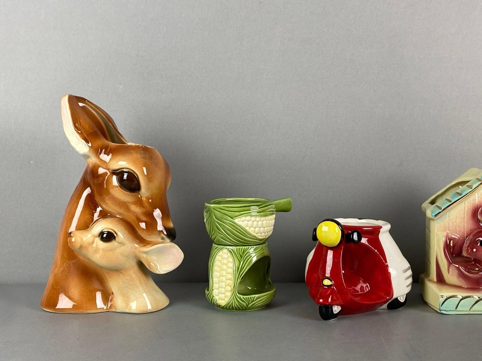 Group of Porcelain Items: Includes mother deer and fawn vase, Italian moped vase, corncob tea light candle and more, largest measures