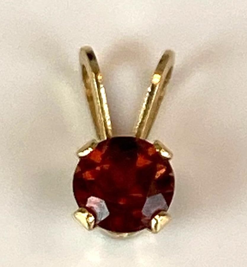 14K Yellow Gold Round Cut Garnet Pendant: Weighs 0.2 grams, measures 1/2 inch