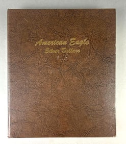 Group of 32 US $1 Silver Eagle Silver Dollars in Folder