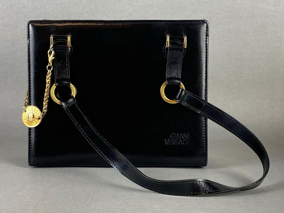 Gianni Versace Black Leather Shoulder Bag with Charm: Minimal signs of wear, Purse body measures 8 1/4 x 10 x 3 1/2 inches.