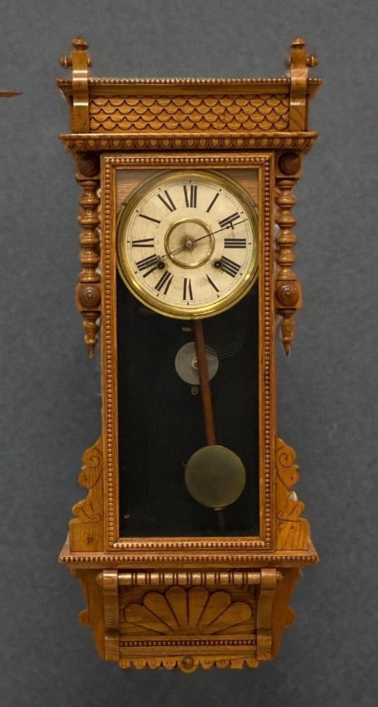Antique WM L Gilbert Clock Co Newport Oak Wall Clock: Worked in tests, includes key, measures 36 x 14 1/2 x 4 1/2 inches
