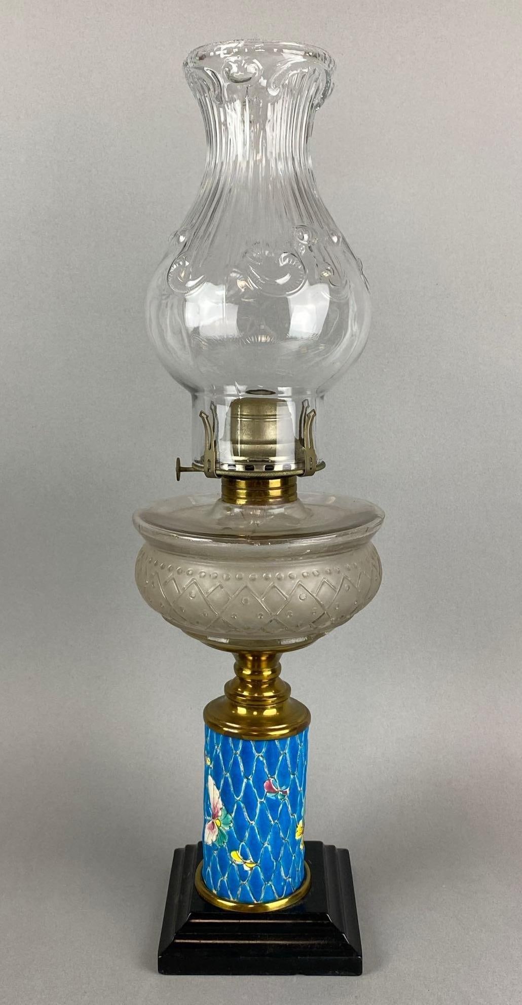 Antique Hand Painted Butterfly Motif Oil Lamp: Chimney lower and upper edge has chipping and a crack. Measures 20 x 6 x 6 inches.