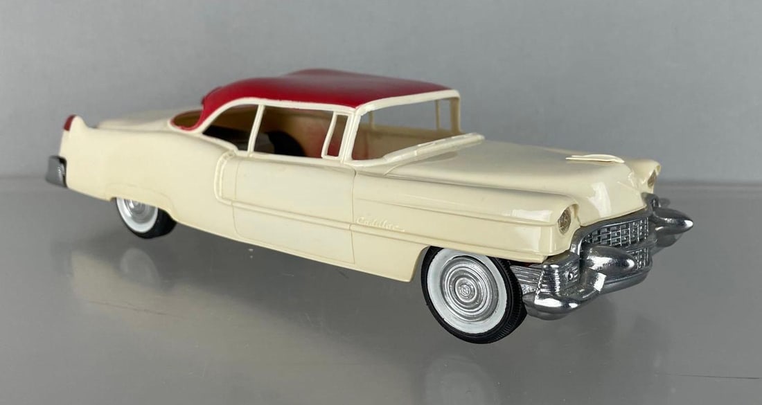 AMT 1955 Cadillac DeVille Dealership Promo Car: Cream and red, missing windows, working friction, some warp
