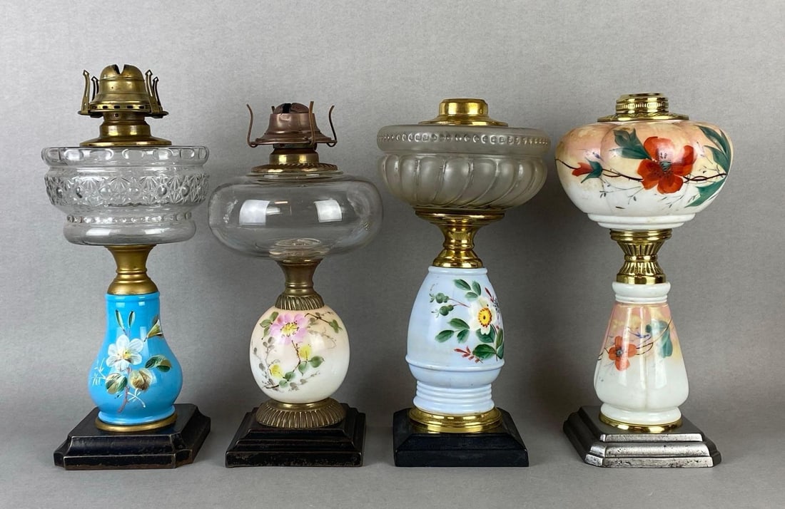 Group of 4 Floral Painted Porcelain Oil Lamp Bases: 3 with clear glass founts, 1 with matching painted floral fount, Tallest measures 14 x 5 1/2 x 5 1/2 inches.