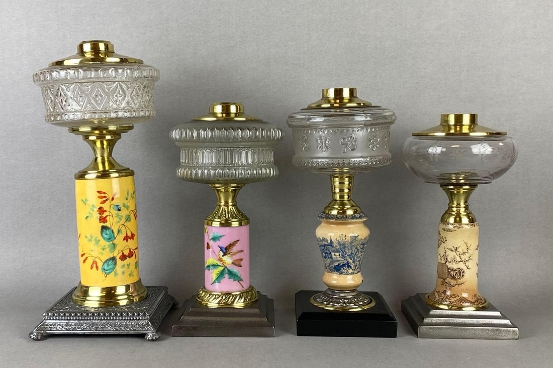 Group of 4 Painted Porcelain Oil Lamp Bases: All with clear embossed or etched glass founts, Tallest measures 14 1/4 x 6 x 6 inches.