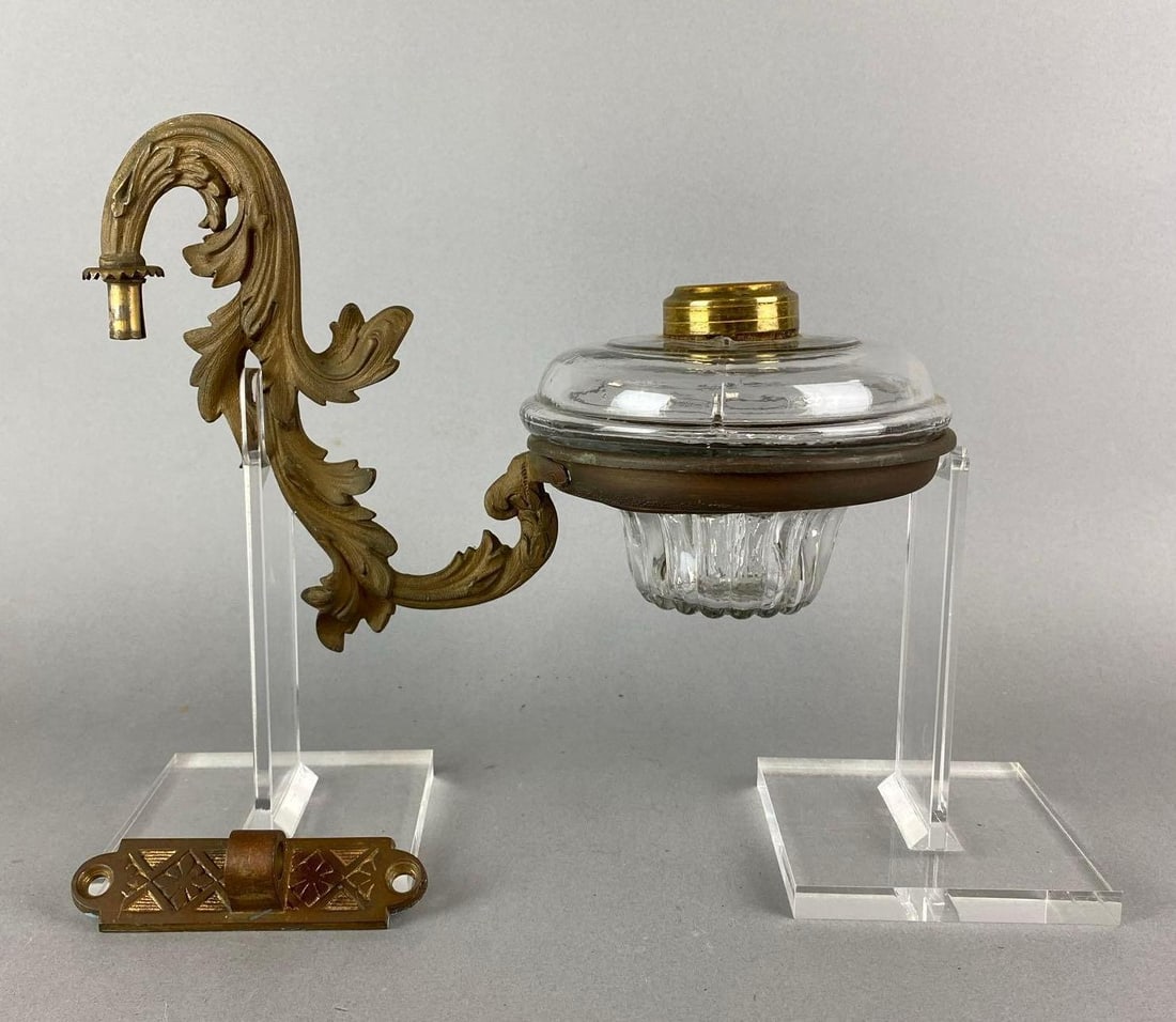 Antique Cast Iron Oil Lamp Wall Sconce: Includes oil lamp. Oil lamp measures 4 1/2 x 6 x 6 inches. Sconce measures 7 1/4 x 5 3/4 x 11 inches.