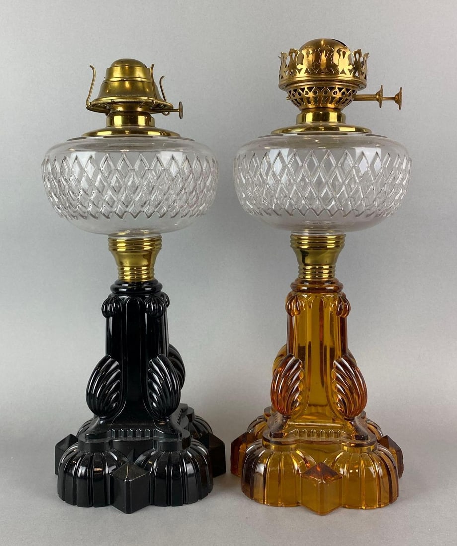 Group of 2 Antique Victorian Palmetto Cathedral Oil Lamps: Amber oil lamp has a chip on base. Largest measures 16 x 6 1/2 x 6 1/2 inches.