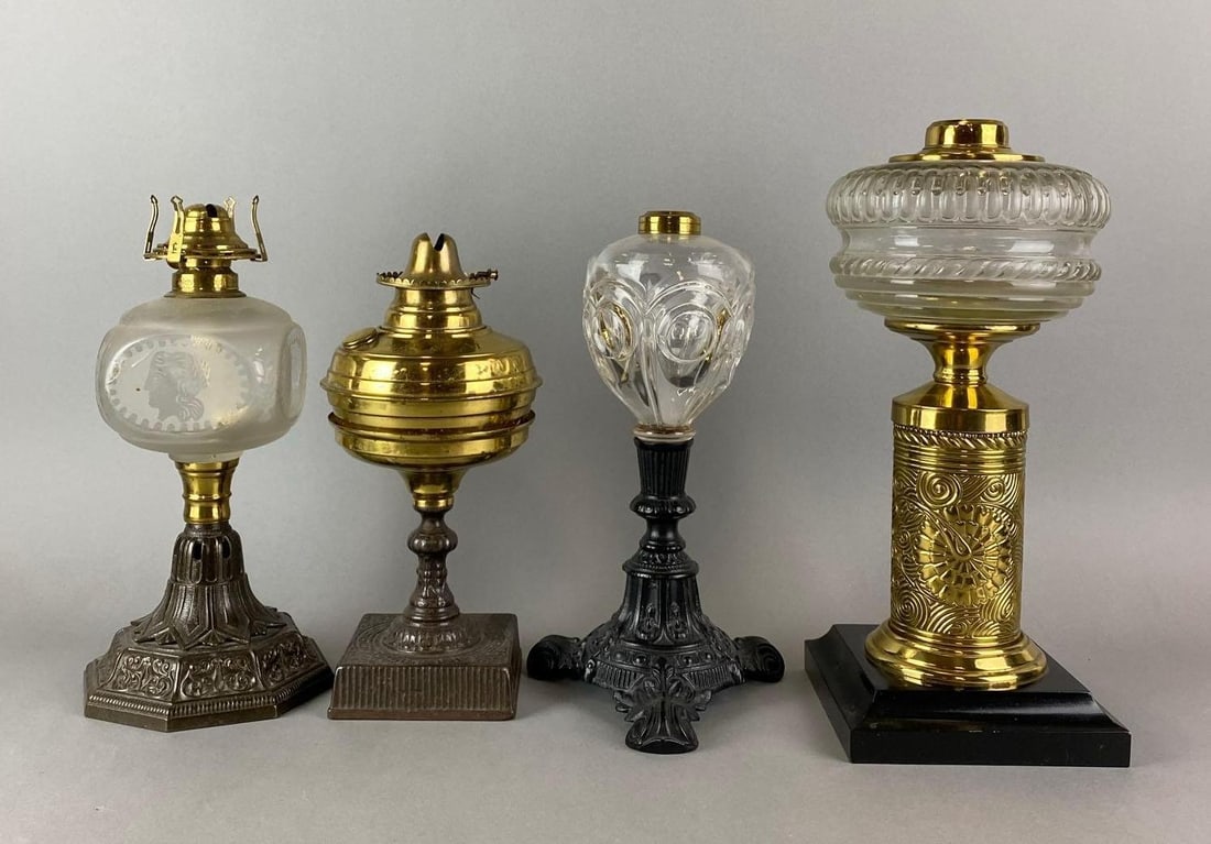 Group of 4 Antique Victorian Ornate Oil Lamps: One has a gouge and one is bruised. Largest measures 13 x 6 x 6 inches.