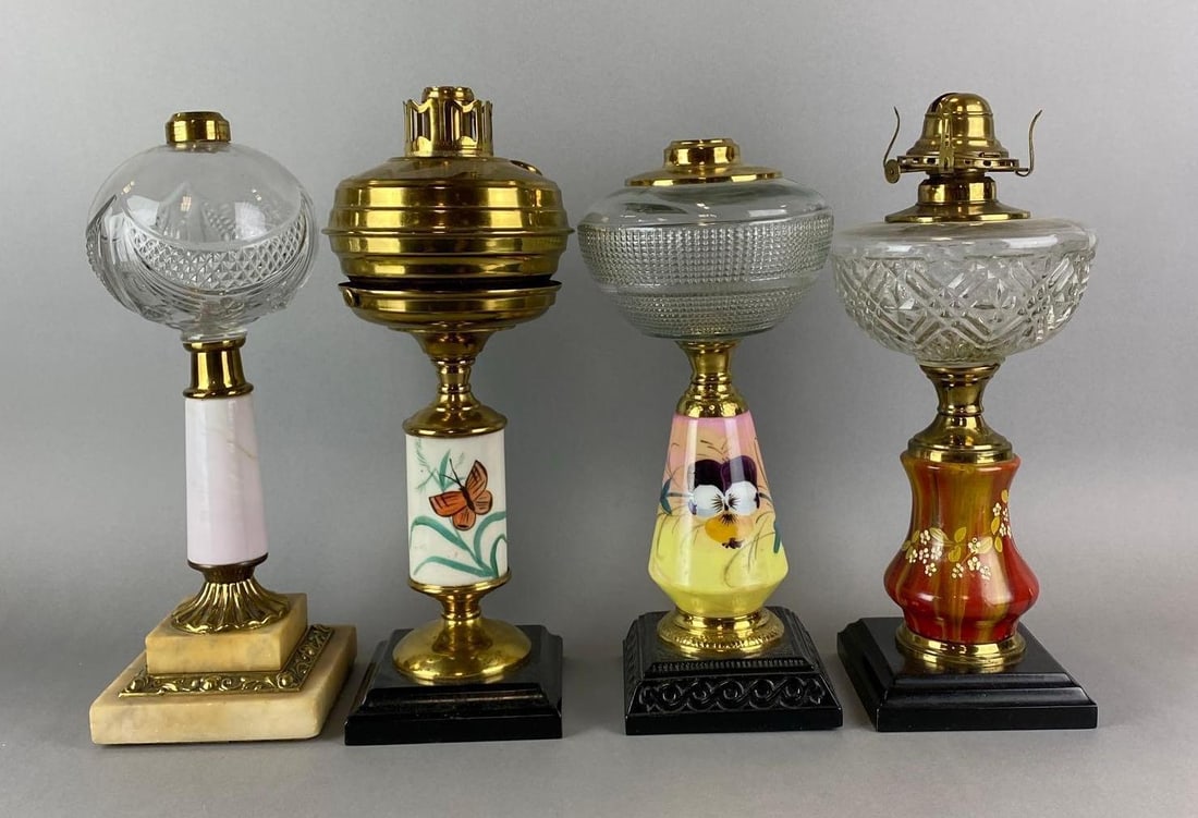 Group of 4 Antique Victorian Oil Lamps: Includes 3 Hand Paint Floral Motif and white glass. Wear is consistent with age. Largest measures 14 1/2 x 6 1/2 x 6 1/2 inches