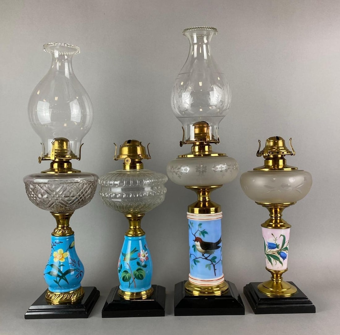 Group of 4 Antique Victorian Floral Motif Oil Lamps: 2 include chimneys. Largest measures 22 1/2 x 6 1/2 x 6 1/2 inches.