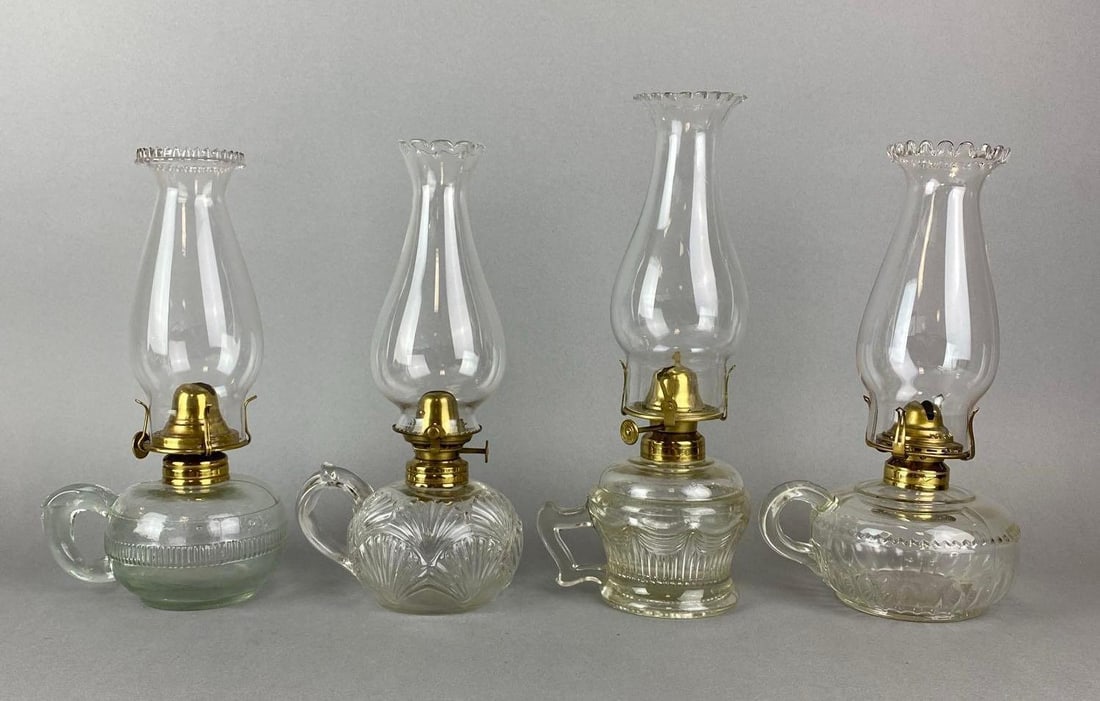Group of 4 Antique Victorian Finger Lamps: One has a chip on the bottom. Largest measures 10 x 6 x 5 inches.
