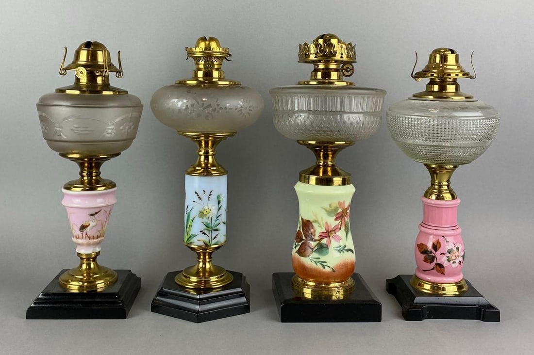 Group of 4 Antique Victorian Hand Painted Oil Lamps: Includes 3 Floral Motif and 1 bird. One has 2 large chips. Largest measures 15 x 6 1/2 x 6 1/2 inches.
