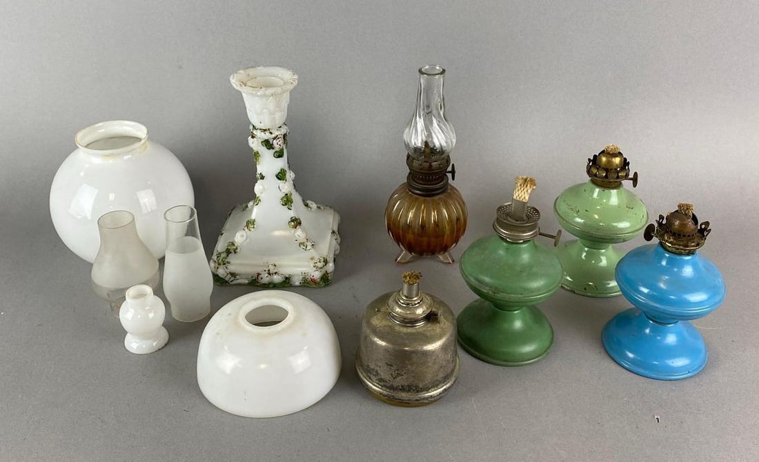Group of Assorted Antique Oil Lamp Parts and More: Includes Candlestick Holder, 3 mini Chimneys, burner and more. Candlestick paint is worn. Wear is consistent with age. Largest item measures 6 1/2 x 4 x 4 inches.