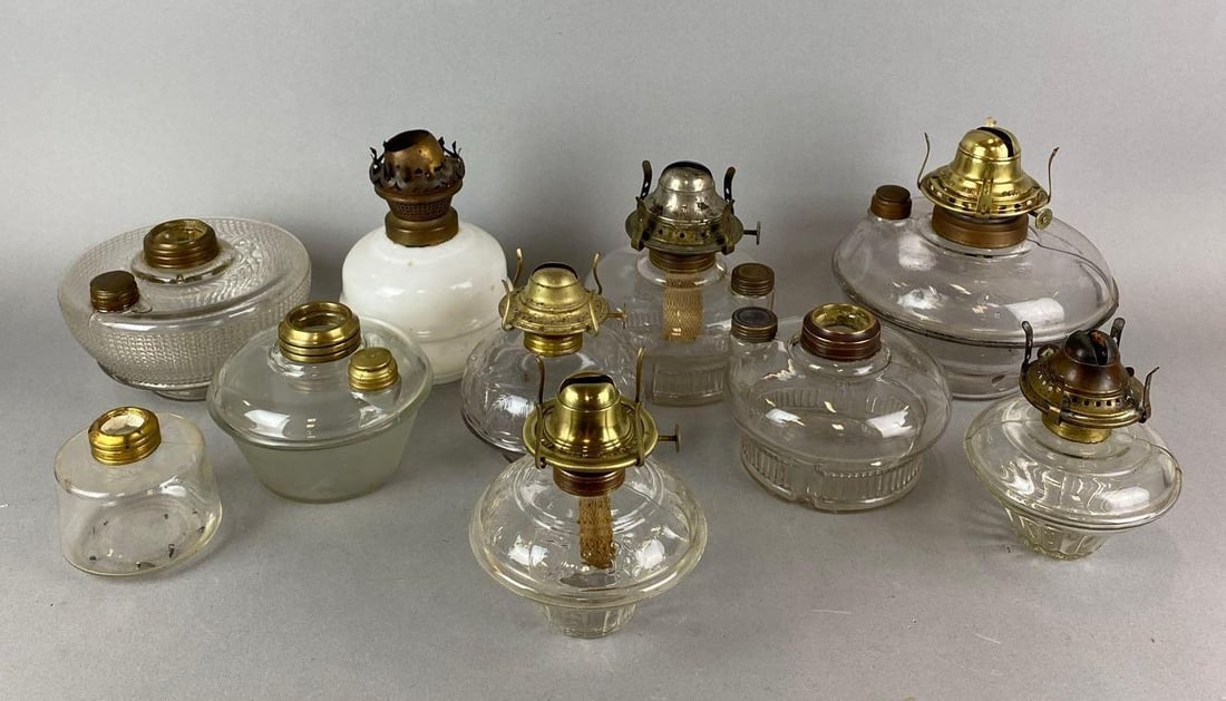 Group of 10 Antique Oil Lamp Fonts: All but one are clear. Largest measures 7 x 8 1/2 x 8 1/2 inches.