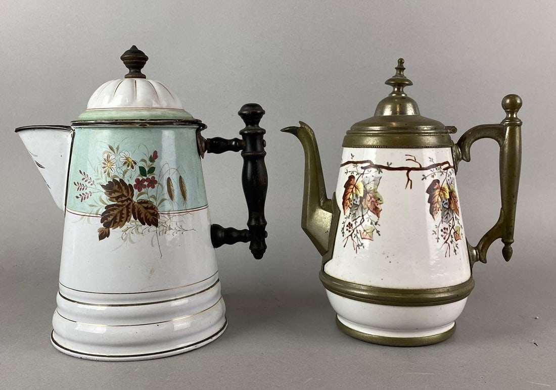 Group of 2 Enamel Hand Painted Floral Motif Coffee Pots: some rust, crazing and a loose lid.present. Largest measures 10 x 8 x 6 inches.
