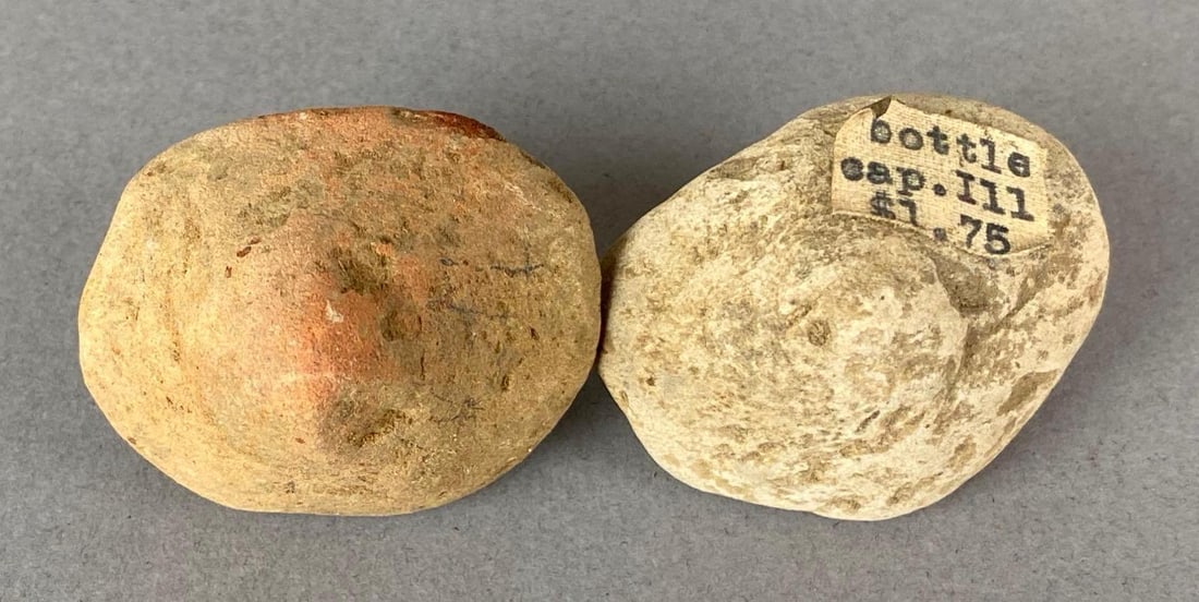 Group of 2 Paleolithic Bottle Caps Heike Collection: One is marked Bottle cap Illinois. Largest measures 1 3/4 x 1 1/2 x 1 1/2 inches.